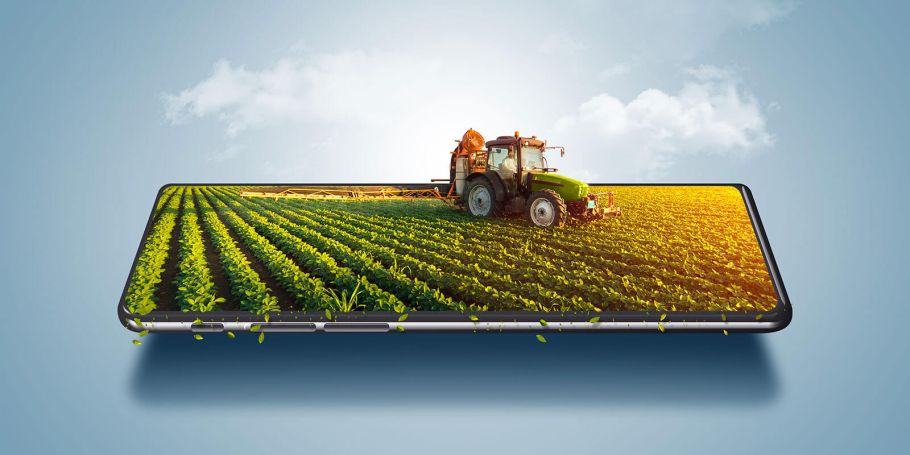Photo of farm equipment coming out of smartphone, blue background and white clouds in the background