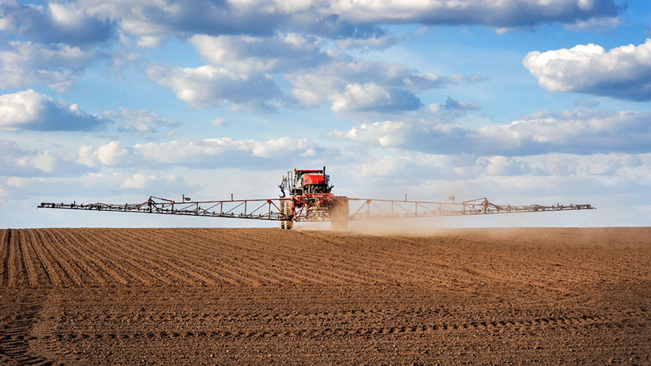 Photo of Farm equipment spraying fertilizer over crop at TCO Agromart